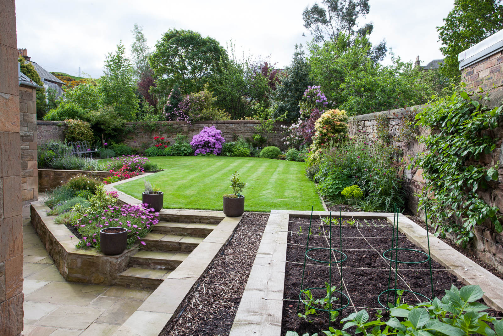 Raised vegetable beds in a multi level walled garden