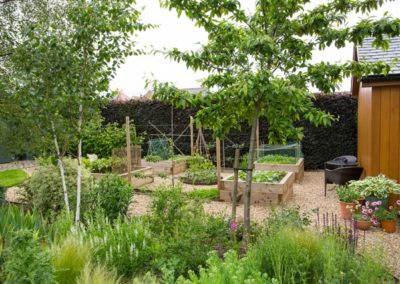 A Potager garden with raised vegetable beds and gravel paths