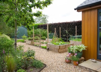 A Potager garden with raised vegetable beds and gravel paths
