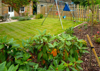 A Family Garden Challenge - with different functional areas including a swing set and football ground