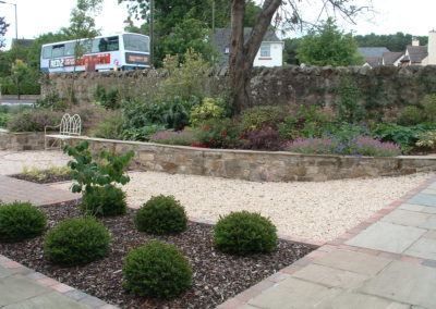 A Linear Focus - stone raised beds with mixed planting