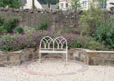 A Linear Focus - stone raised beds with a recessed seating area