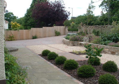 A Linear Focus - drive, raised beds incorporating seating area and geometric planting